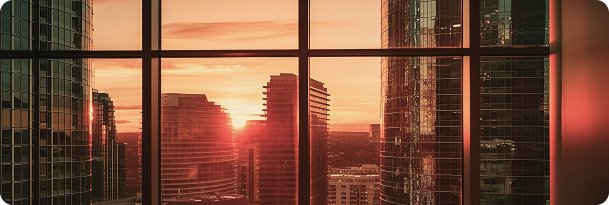 Sunset view of modern city skyline from office window, symbolising new horizons and opportunities with WIUS Capital