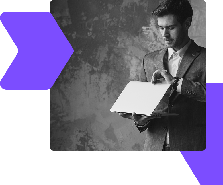 Focused businessman in suit using laptop, representing insights, strategies, and opportunities shared through the WIUS Capital blog