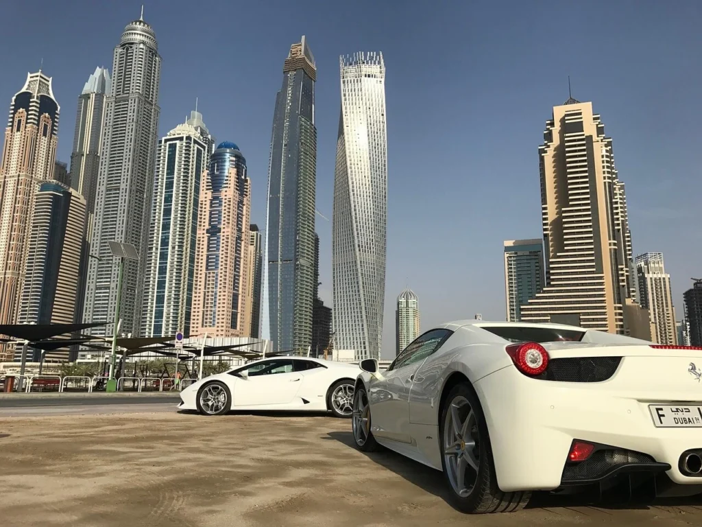 Dubai Marina skyline with luxury cars in the foreground, symbolising international wealth and investment hubs.