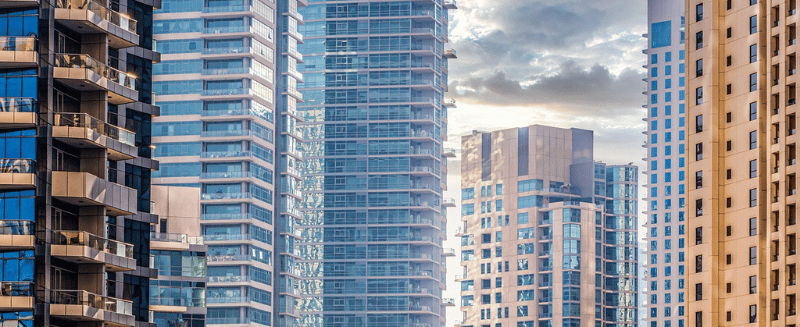 Modern high-rise buildings representing global financial and corporate markets.