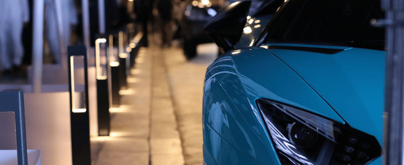 Luxury car on a city street at night, symbolising exclusivity and wealth, used to illustrate a WIUS Capital blog on private credit vs bonds and how investors assess protection and returns.