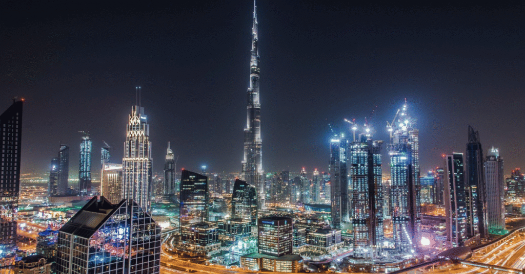 Night-time view of downtown Dubai with the Burj Khalifa and illuminated highways, reflecting WIUS Capital’s global base.