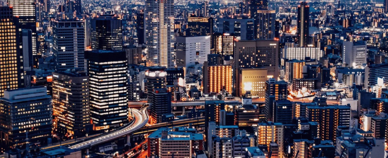 International city skyline at night symbolising cross-border global M&A investments and institutional-grade acquisition strategies.